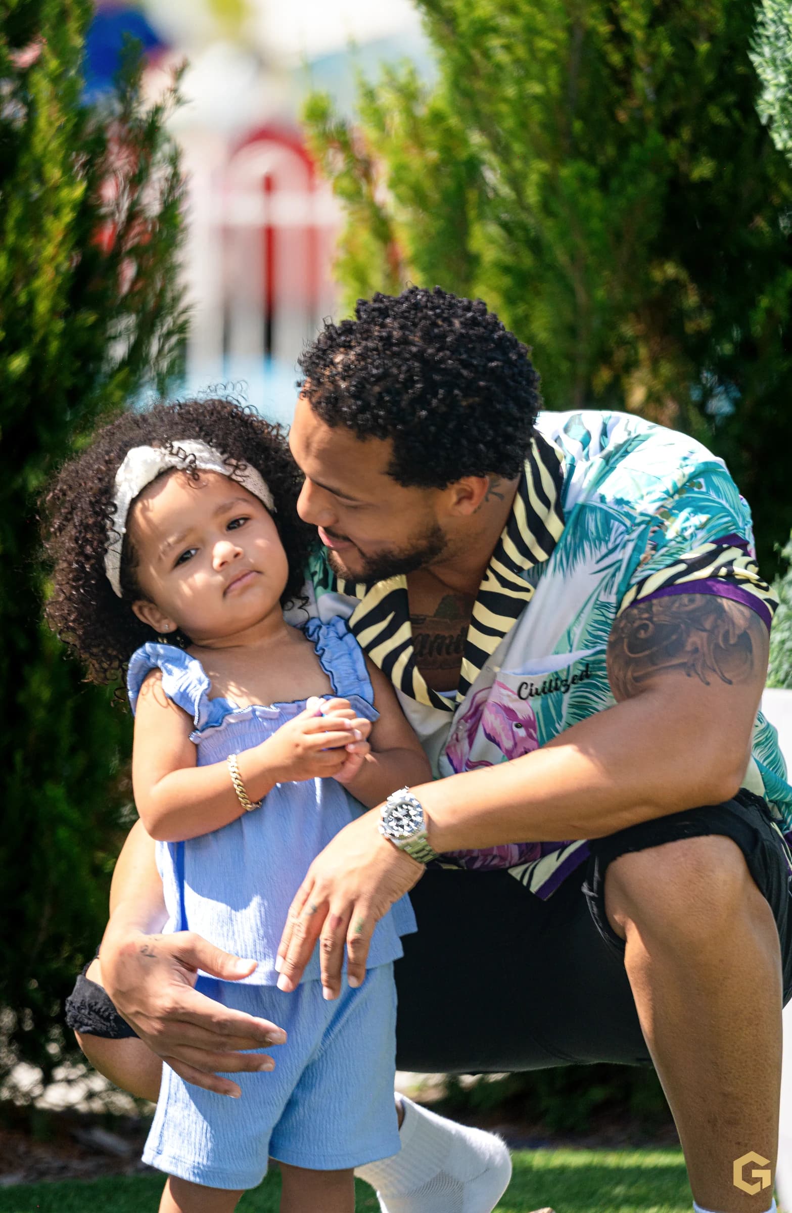 A close father-daughter portrait among the greenery