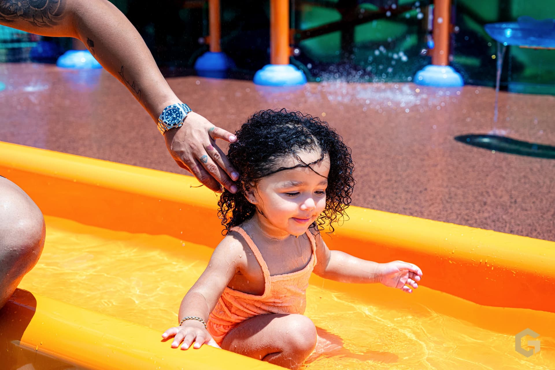 A gentle moment between father and daughter in the water