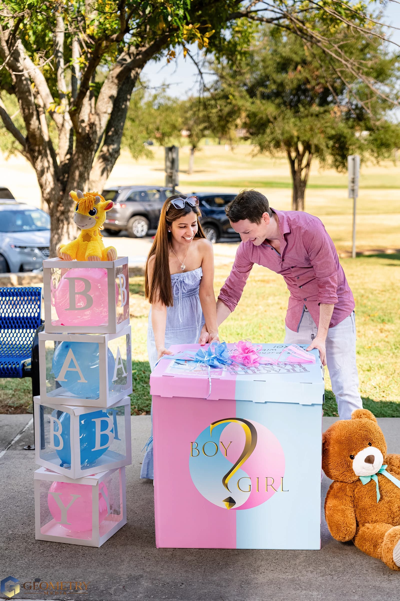A moment of anticipation as the couple reach for the reveal box