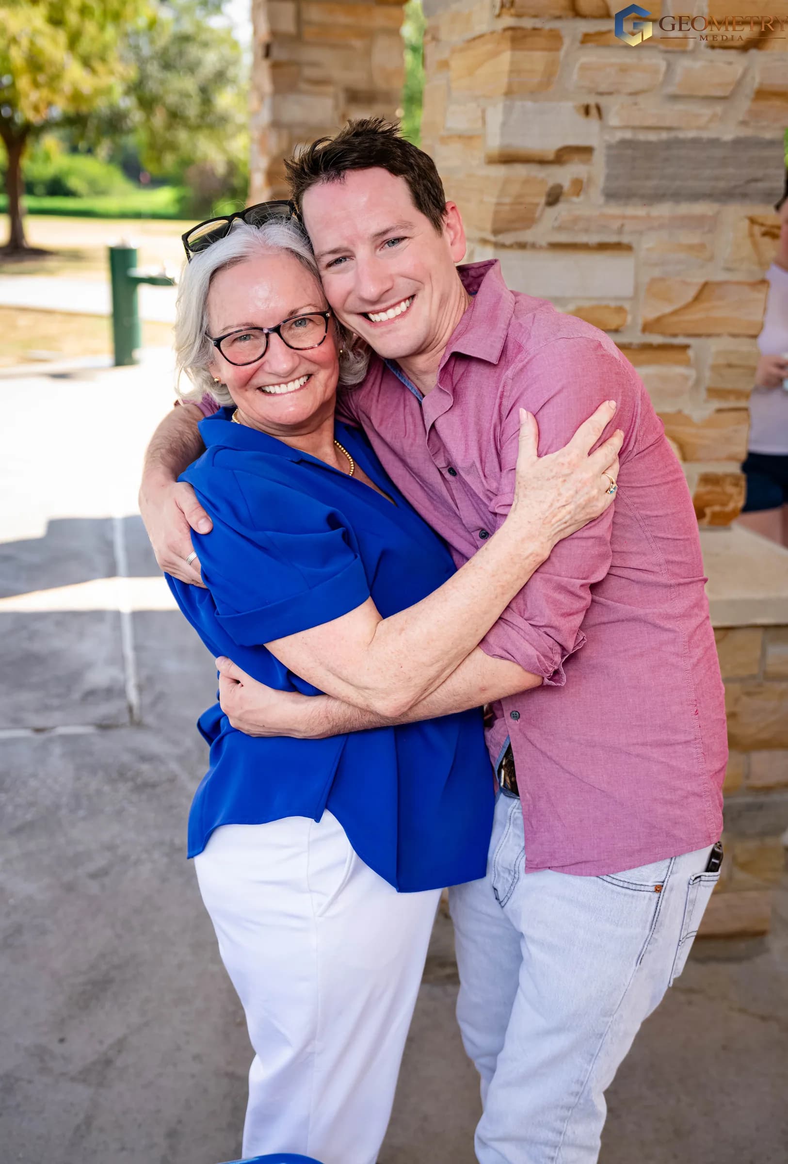 A warm embrace between the father-to-be and a family member