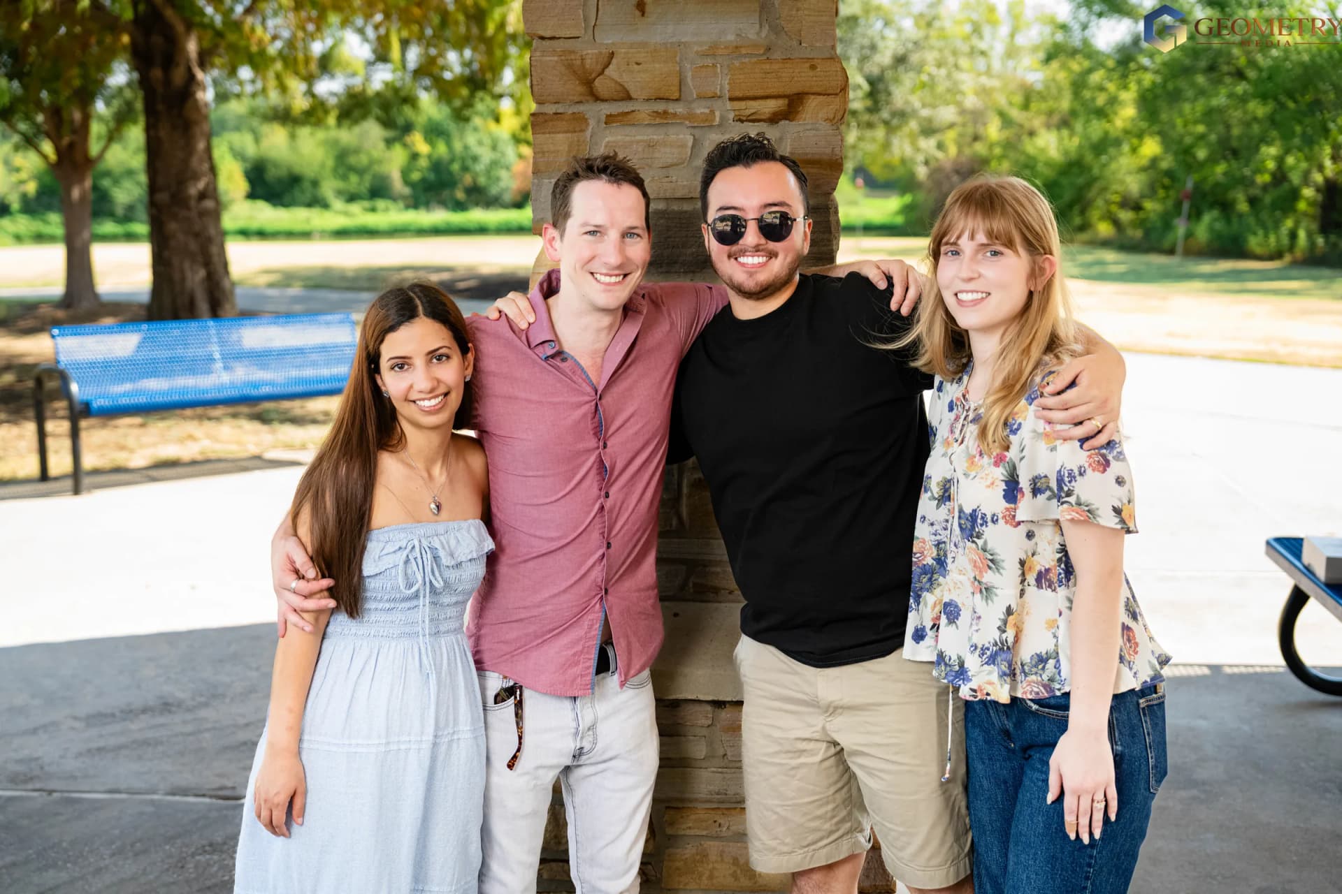 The expectant parents share a relaxed group portrait with friends