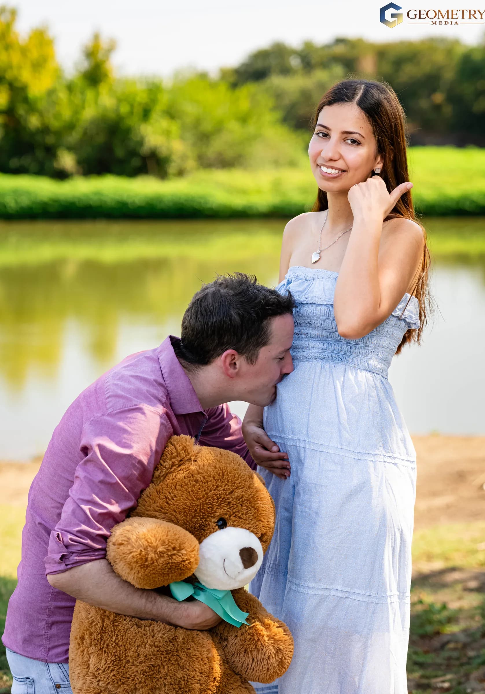 A tender maternity portrait with the father, mother and teddy bear