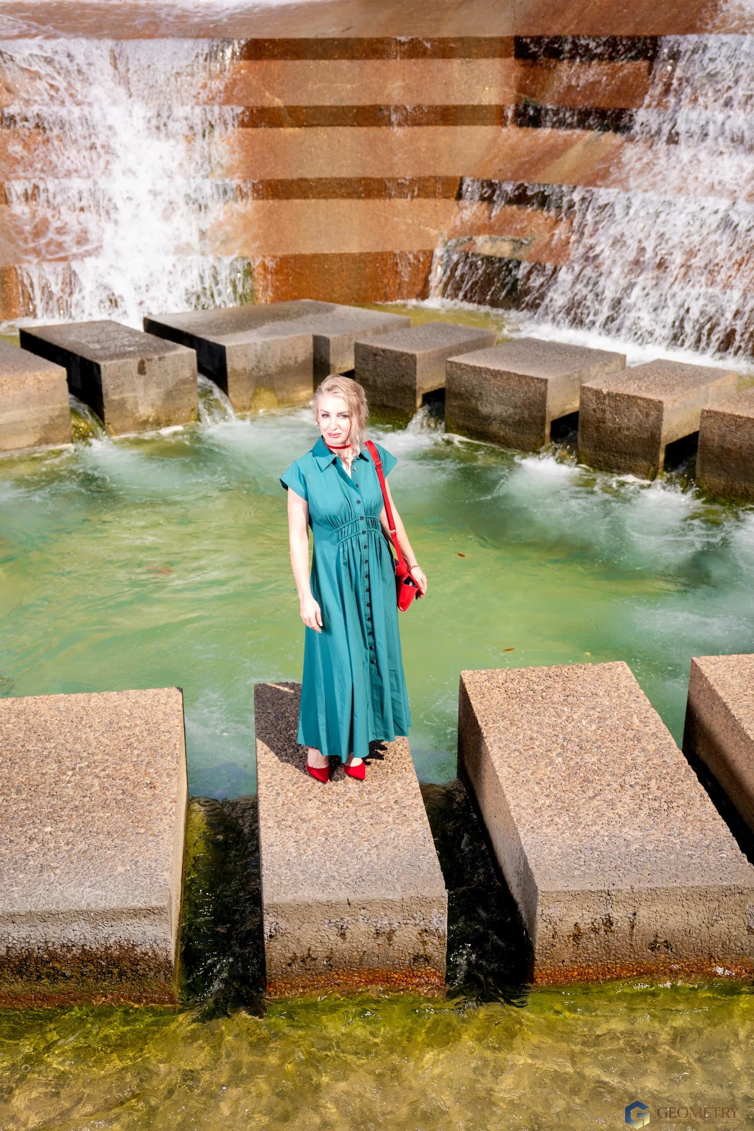 Elegant family portrait in jewel tones beside the fountain